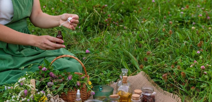 A woman makes herbal tincture. Selective focus. Nature.