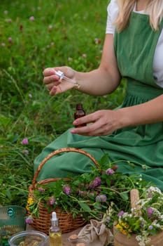 A woman makes herbal tincture. Selective focus. Nature.