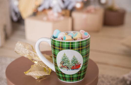 Close-up image, A tasty hot melted chocolate with tiny marshmallows cup in a woman's hand. Winter drinks concept