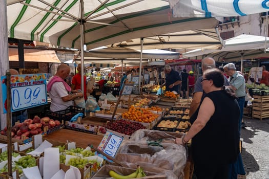 Palermo, Italy - July 20, 2023: Market stalls and people at famous and historical Ballaro Market