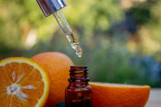 Essential extract of orange oil in a small bottle.