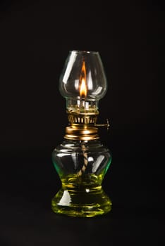 An antique oil lamp, symbolizing Diwali's essence, illuminated against a dark background. Perfect for conveying festive greetings and vintage aesthetics.