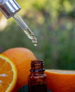 Essential extract of orange oil in a small bottle.