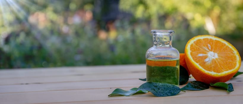 Essential extract of orange oil in a small bottle.