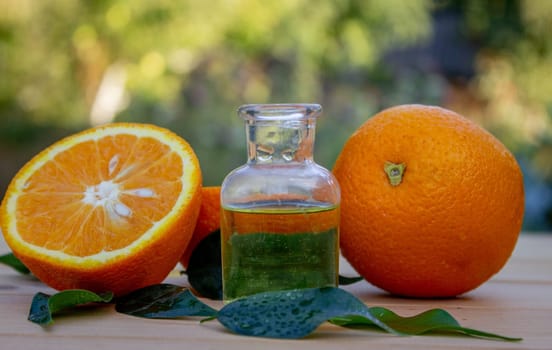 Essential extract of orange oil in a small bottle.