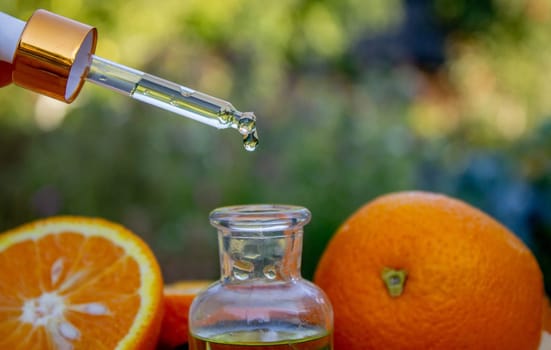 Essential extract of orange oil in a small bottle.