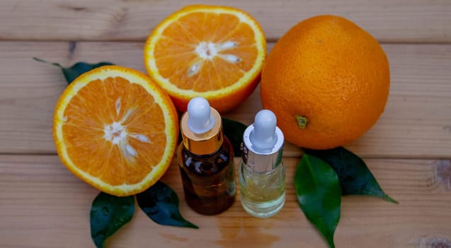 Essential extract of orange oil in a small bottle.