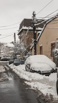 Cars covered in snow, first day of winter in Bucharest City, Romania