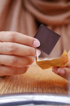 removing packet from a chocolate .