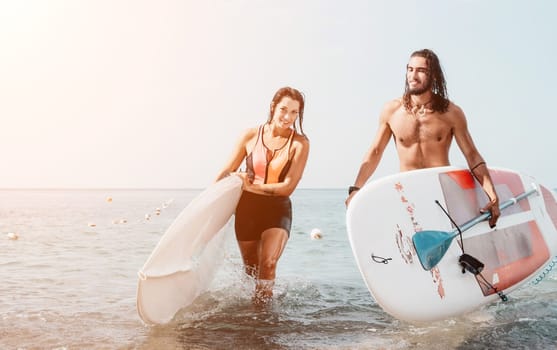 Woman man sea sup. Close up portrait of beautiful young caucasian woman with black hair and freckles looking at camera and smiling. Cute woman portrait in a pink bikini posing on sup board in the sea
