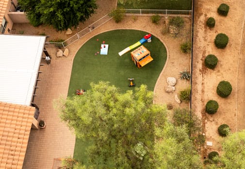 Aerial Top View Of Backyard with Play Yard or Playground Trees and Lawn. Residential Area. Relaxing Outdoor Area. Horizontal Plane High quality photo