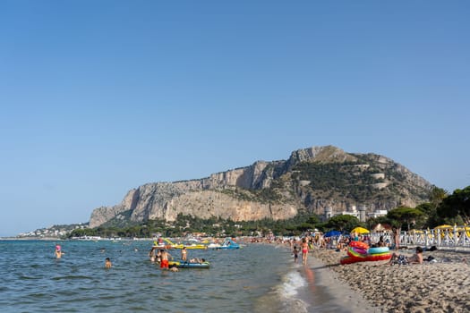 Mondello, Italy - July 17, 2023: People at popular Mondello Beach.