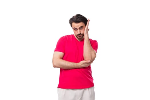portrait of a young brutal man with black hair dressed in a red t-shirt with a mockup.