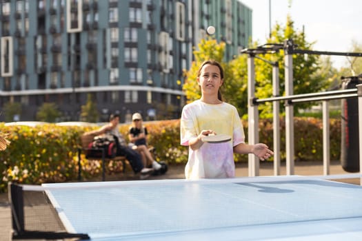 girl plays in table tennis outdoor. High quality photo