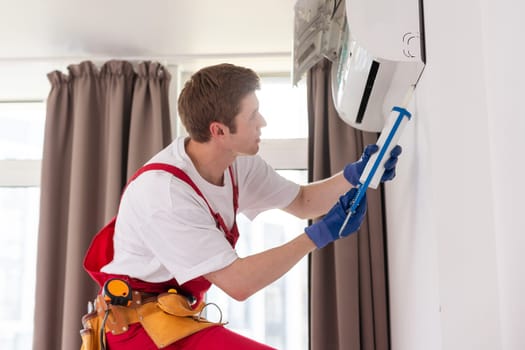 Service man is cleaning, repair and maintenance of air conditioner.