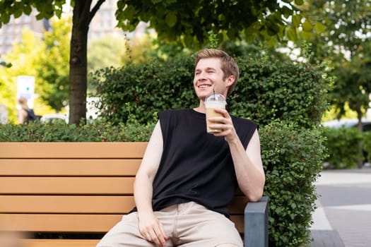 Hipster holding iced coffee in the city