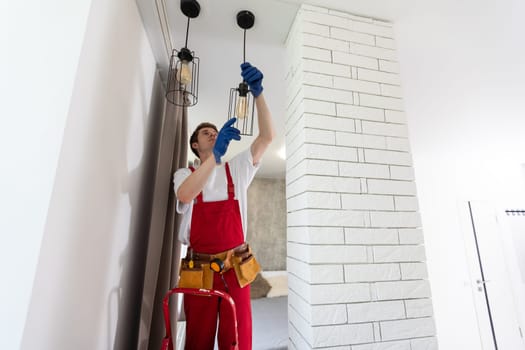 man changing led ceiling lamp in new house.