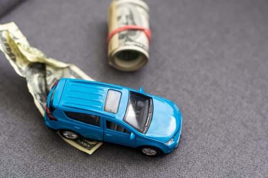 Saving money to buy a car. Toy car with money cash. High quality photo