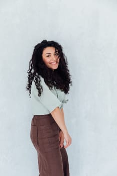 Portrait of a fashionable woman with black curly hair