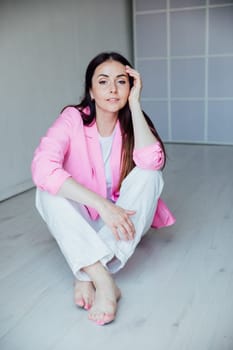 Portrait of a beautiful woman in white clothes and pink jacket