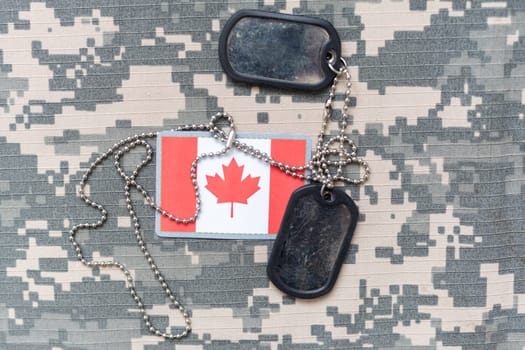 army blank, dog tag with flag of canada on the khaki texture background. military concept. High quality photo