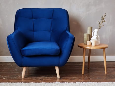 furniture, interior, home design. modern blue fabric armchair with wooden legs, front view.