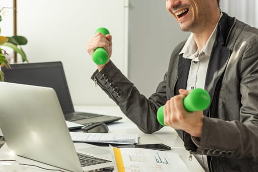 Businessman Doing Exercise With Dumbbell. High quality photo