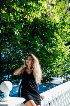 woman in black summer dress walking through the streets of the city