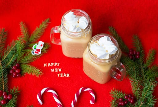 marshmellou cocoa and candy on a red background. The inscription Happy New Year.