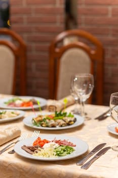 Served festive table with snacks, glasses, glasses, cutlery and napkins for a banquet on the occasion of a wedding or birthday or Christmas or other bright event in the restaurant