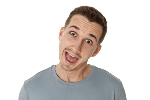 portrait of young funny man grimacing on white background