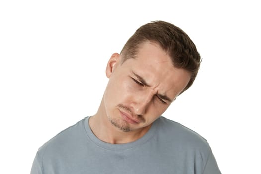 Portrait of frustrated young man on white background. sadness
