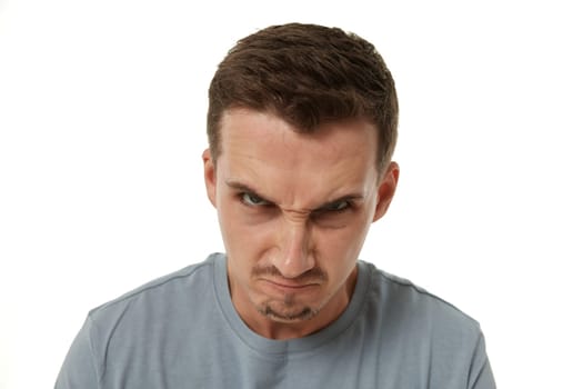 angry guy looking at camera on white studio background