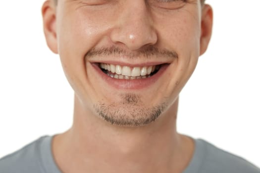 mouth and teeth of smiling man on studio background. male face with clean teeth