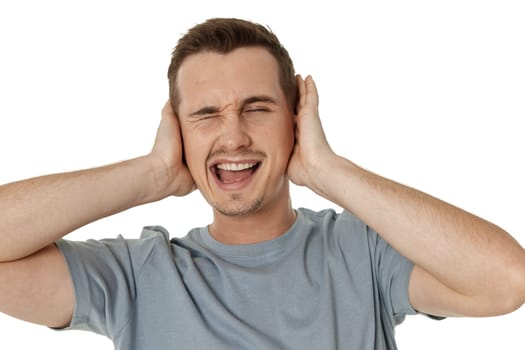 caucasian man in t-shirt covers ears with hands on white background