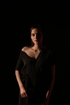 Portrait of a beautiful woman in black clothes at night