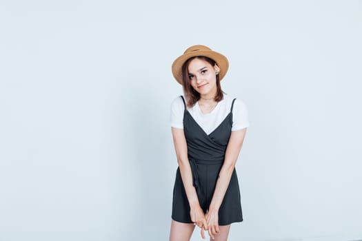 Portrait of a beautiful woman in a black dress and hat