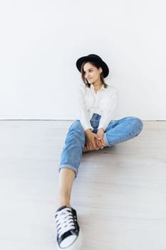 Portrait of young brunette woman in home clothes