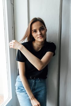 Portrait of young brunette woman in home clothes