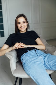 Portrait of young brunette woman in home clothes