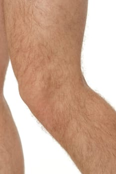 male legs close up on white studio background. knee