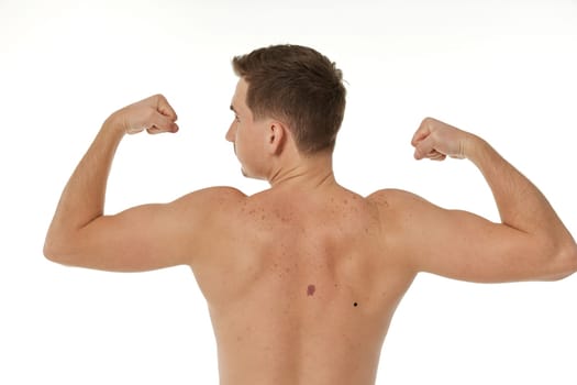 young man showing his bicep over white background. Rear view