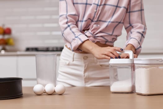 Happy baker woman preparing pie in modern kitchen