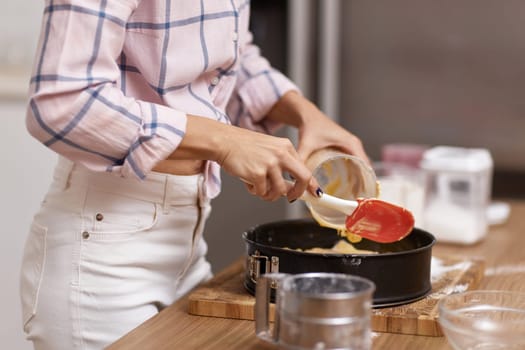 housewife woman baking pie in modern kitchen