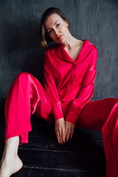 Beautiful woman in 40 years old in red silk pajamas