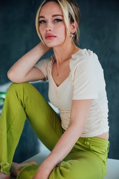 Beautiful blonde woman sitting on the table