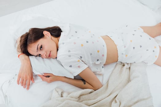 woman in pajamas sleeping in bedroom on bed