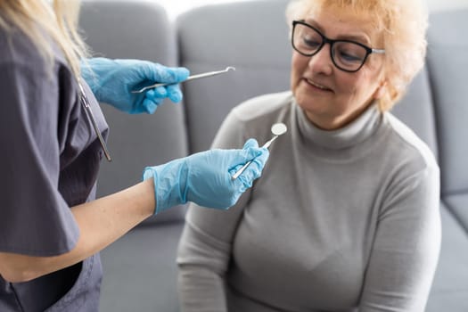 Close up portrait of elderly beautiful woman check up and having the consultation with dentist at the dental office