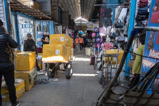 Asian bags on Dordoi Bazaar under roof in Bishkek, Kyrgyzstan - October 10, 2022