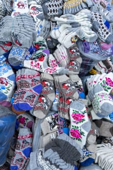 Many warm winter socks at asian Dordoi Bazaar under roof in Bishkek, Kyrgyzstan - October 10, 2022